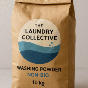 A 10 kg brown kraft paper bag of “The Laundry Collective” Washing Powder – Non-Bio. The bag’s surface shows natural creases and matte texture, with the same printed blue and white circular logo featuring bubbles. The words “Washing Powder” and “Non-Bio” are printed on the front, with “Non-Bio” in blue text, set against a light grey background for a clean, modern look.